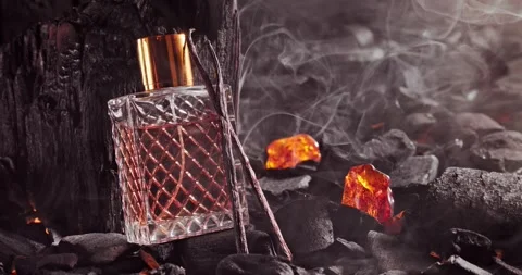 Unique incense perfume in translucent glass bottle on coal. Stock Footage 331791082