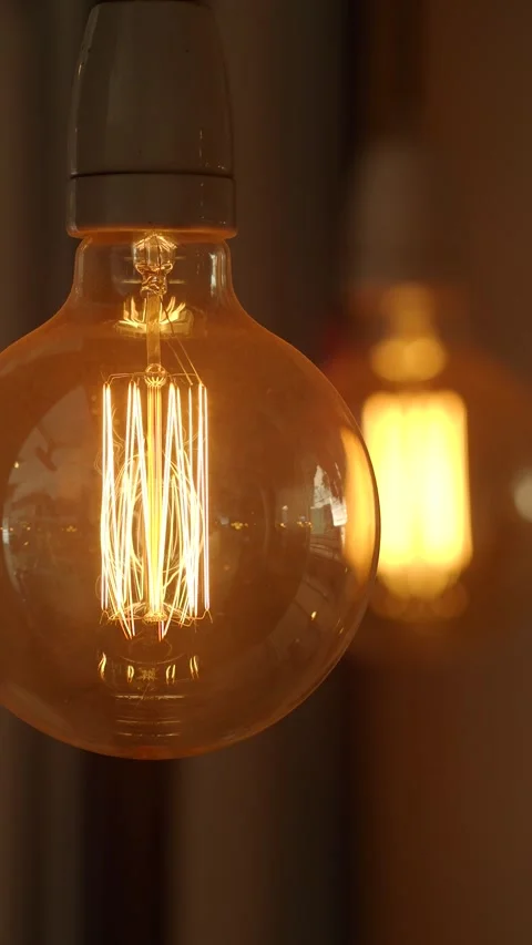 Unique light bulbs glowing in warm ambiance at night Stock Footage 317281439