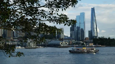 Unique looking pleasure cruiser passes Sydney cityscape 6K Stock Footage 309292932