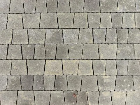 Unique pattern of cobblestones creates a rustic pathway in a quiet area Stock Photos