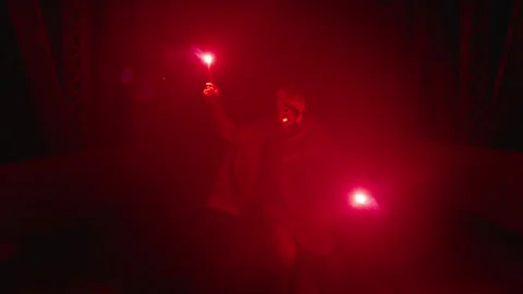 Unique performance with flare smoky red glow on bridge at night Stock Footage 320012862