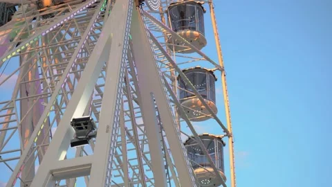 Unique perspective, close up of spinning Ferris wheel with glass cabins Stock Footage 180003661