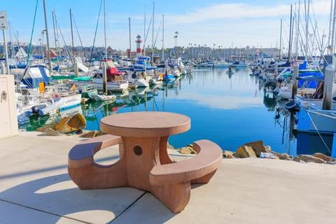 Unique Picnic Table Overlooking Oceanside Marina with Sailboats 스톡 사진