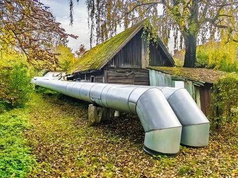 A Unique Pipe Structure Positioned Right Beside a Charming Rustic Barn in the Stock Photos