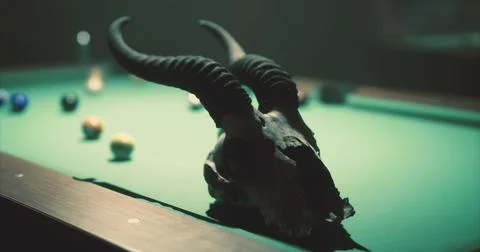 Unique pool table setup featuring a goat skull and scattered billiard balls Stock Illustration