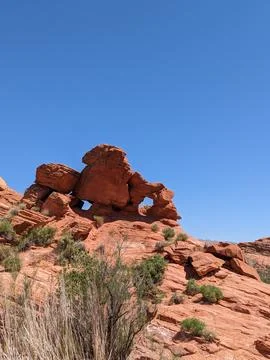 Unique Red Rock Formations at Sand Hollow State Park Under a Bright Blue Sky 写真素材