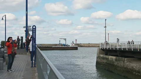 Unique road swing bridge in action at narrow harbour entrance, Port-en-Bessin 4K Stock Footage 137448398