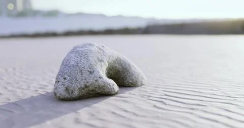 Unique rock formation on sandy beach during sunset near coastal area Stock Illustration