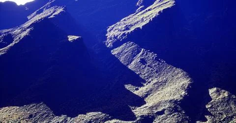 Unique rock formations with dramatic shadows under sunlight in a canyon Stock Illustration