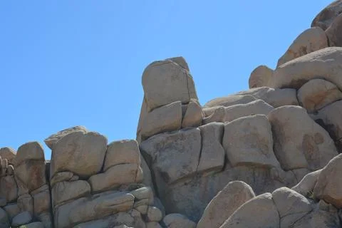 Unique Rock Formations Under Clear Blue Sky at Midday in Natural Landscape Stock Photos