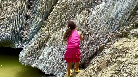 A unique rock made of salt crystals. A little girl examines salt Stock Footage 250186530