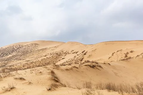 A unique sandy mountain in the Caucasus on a cloudy day. Stock Photos