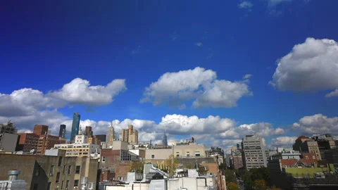 Unique shape clouds float over East Village buildings NYC. Stock-Footage 163919189
