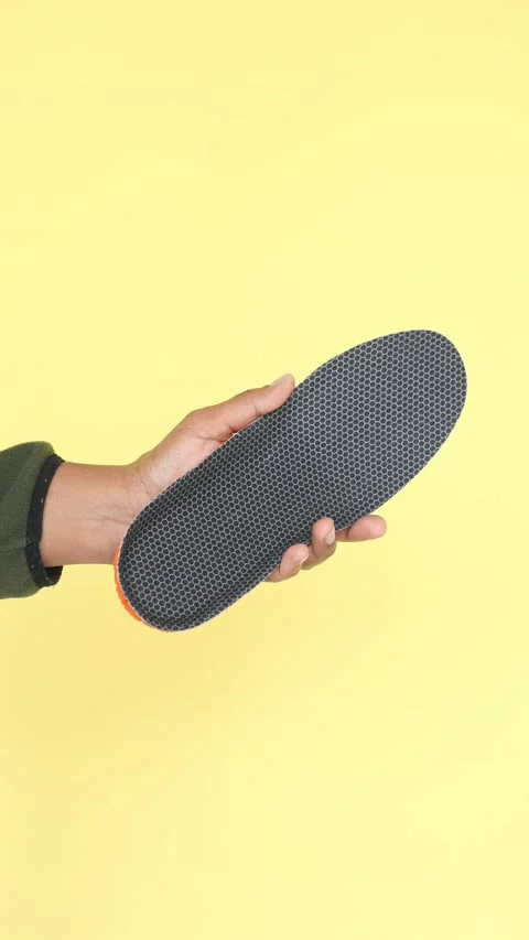 Unique shoe insole displayed against vibrant yellow background Stock Footage 308143265