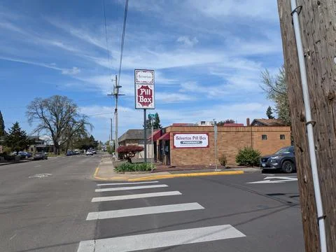 Unique Silverton Pill Box pharmacy sign rises above a quiet downtown Фото