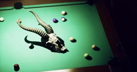 Unique table setup with horned skull and colorful billiard balls Stock Footage 312159145