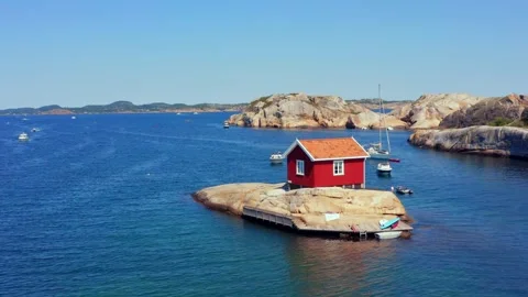 Unique tiny summer house cabin in Norway. Boats and kayaks Norwegian island Stock Footage 320498609