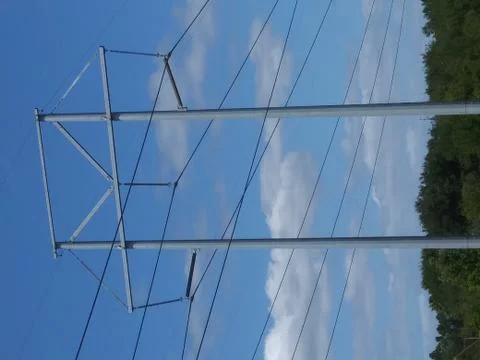 Unique utility pole across blue skies and clouds Stock-Fotos