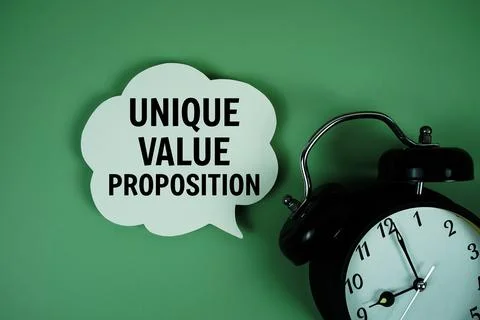 Unique Value Proposition text on speech bubble with alarm clock on green ba.. Stock Photos