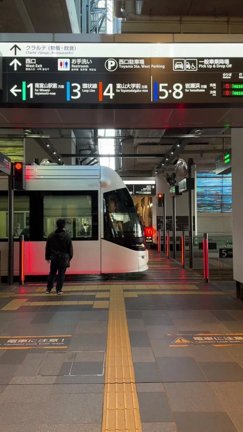 A unique view of a city tram passing through Toyama Station  Stock Footage 277763277