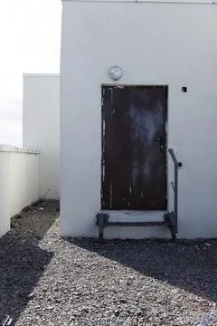 Unique View of an Exiting Doorway on Flat Roof with Gray Gravel and Bright Stock Photos