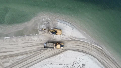 Unique view of a large excavator loading sand on a dump truck for a Stock Footage 156530140