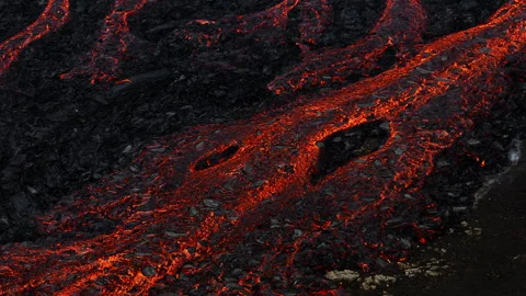 Unique view of molten lava flow burning and slowly moving, aerial close up shot Stock Footage 262573954