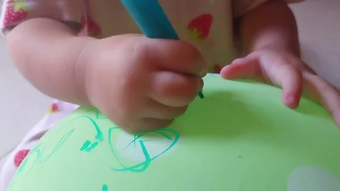 Unique Way of Teaching Toddlers to Write: Using Markers to Scribble on Balloons Stock Footage 239921445