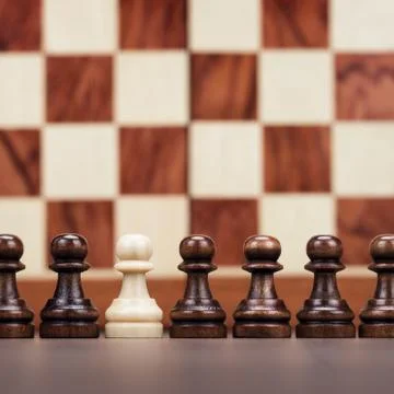 Uniqueness concept over chessboard background Stock Photos