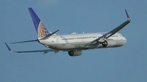 United Airlines airplane banks left after taking off Stock Footage