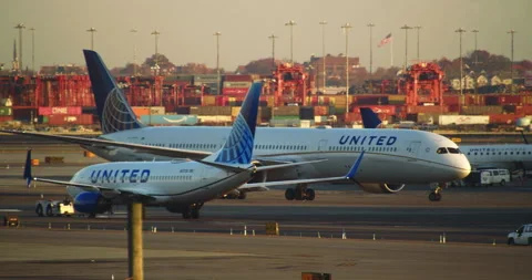 United Airlines Commercial Airliners on Tarmac at Sunset. Stock Footage