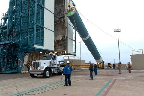 United Launch Alliance (ULA) workers assist as the Delta II first stage is... Stock Photos