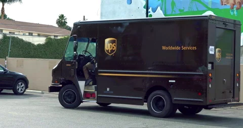 United Parcel Service worker from UPS truck delivering  package to customer, 4K Stock Footage 143581967
