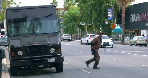 United Parcel Service worker from UPS truck delivering  package to customer, 4K Video stock 143583092