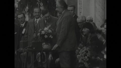 UNITED STATES 1930s: Albert Einstein speaking on stage, people sit in Stock Footage 301943795