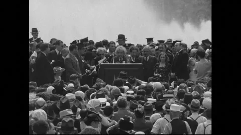 UNITED STATES 1930s: Albert Einstein speaking at podium in front of fountain. Stock Footage 301944401