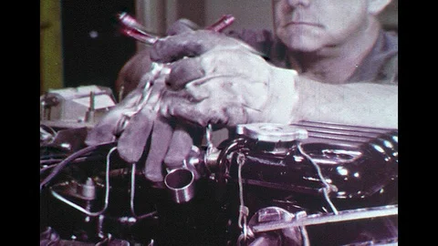 UNITED STATES 1930s: Starter Engine Being Tested by Man in a Factory Video stock 74969851