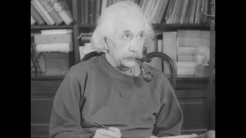 United States 1940s: Albert Einstein in his study and on a porch. He smokes a Stock Footage 325219473
