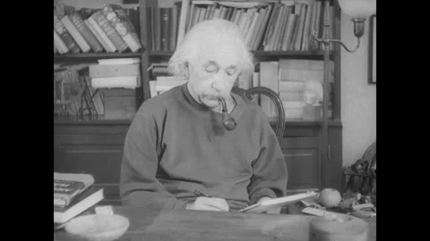 United States 1940s: Albert Einstein at his desk, writing on a notepad while Stock Footage 325219487