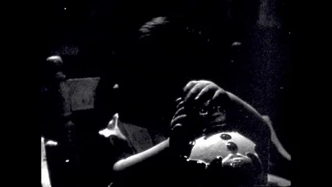 UNITED STATES: 1940s: Baby plays with toy clown at high chair. Child upset about Stock Footage