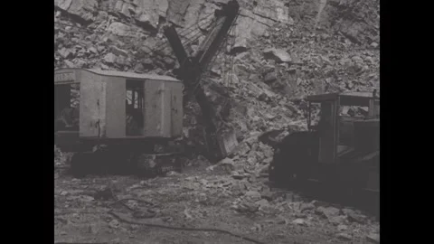 United States 1940s: A mining train moves along tracks in a rocky underground Stock Footage 340084950