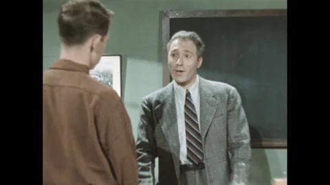 UNITED STATES 1940s: A person holding a film clapperboard in a grassy area, Vídeos de archivo 310006749