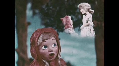 UNITED STATES 1940s: A puppet dressed as Little Red Riding Hood walks through a 스톡 동영상 337182570