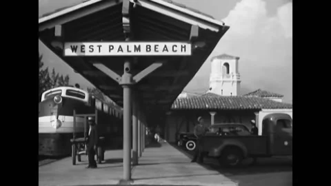 UNITED STATES - 1940s - A train pulls into the Palm Beach train station. WAVES Stock Footage 316682409