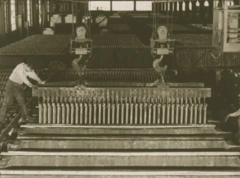 UNITED STATES 1940s: Workers move along large industrial conveyor belts in an Stock Footage 337110936