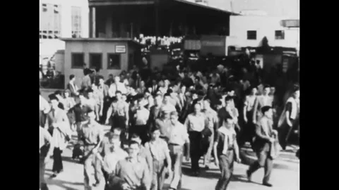 UNITED STATES - 1942 - Crowds of workers cross the road and enter factories. Men Stock Footage 341990585