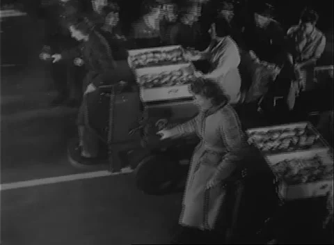 UNITED STATES - 1942: Shift-break traffic - Workers carry trays through plant Stock Footage 344508932
