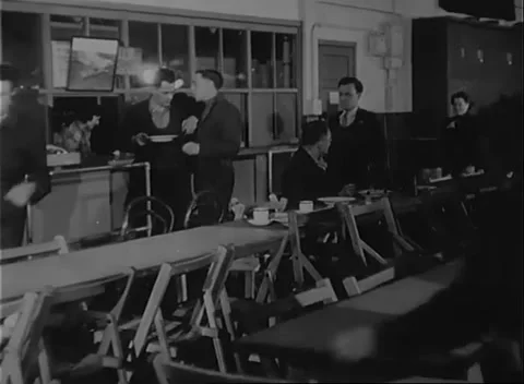 UNITED STATES - 1942: Workforce dining - Employees share food and drinks Stock Footage 344508986