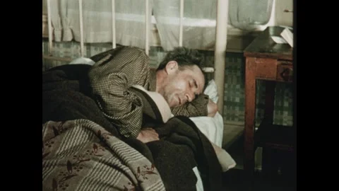 UNITED STATES 1950s: Clock on bedside table. Man lies in bed, man gets out of Stock Footage 332376244