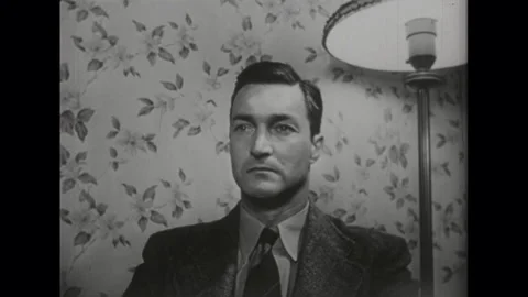 United States 1950s: Close up of man sitting, man leans forward, puts head in Stock Footage 328589056